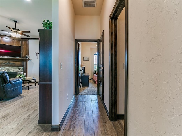 3424 Lakeside Dr, Moore, OK 73160 - hallway with wood finished floors, baseboards, and a textured wall