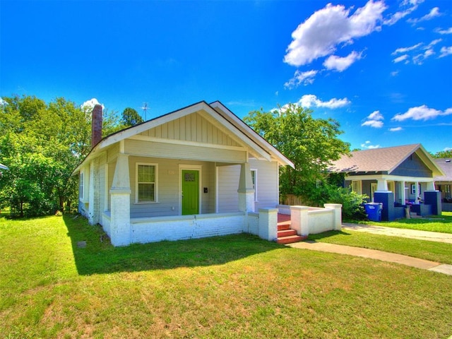 1017 N Broadway Ave, Shawnee, OK 74801 - bungalow-style house featuring a chimney, a front yard, and a porch