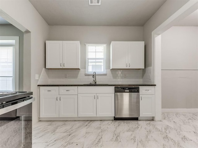 1017 N Broadway Ave, Shawnee, OK 74801 - kitchen with stainless steel dishwasher, a sink, white cabinets, and dark countertops