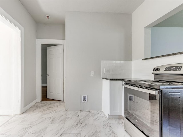 1017 N Broadway Ave, Shawnee, OK 74801 - kitchen featuring stainless steel electric stove, light marble finish flooring, white cabinetry, and tasteful backsplash