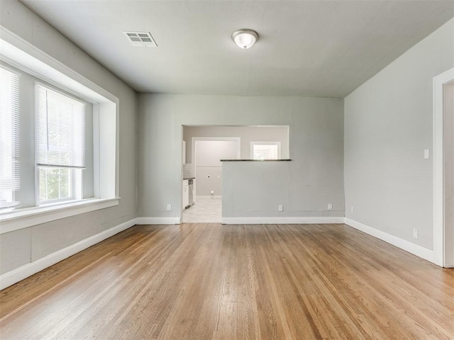 1017 N Broadway Ave, Shawnee, OK 74801 - unfurnished room featuring light wood-style floors, plenty of natural light, and baseboards