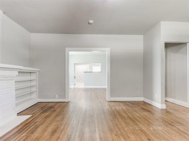 1017 N Broadway Ave, Shawnee, OK 74801 - unfurnished living room with baseboards and wood finished floors