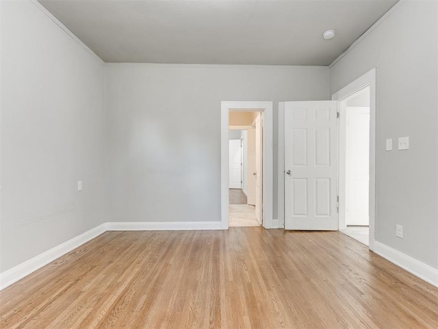 1017 N Broadway Ave, Shawnee, OK 74801 - empty room with light wood finished floors, baseboards, and crown molding