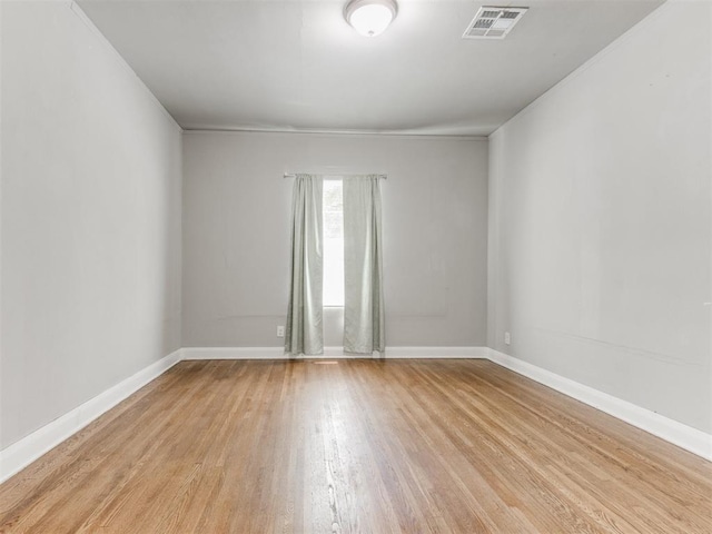 1017 N Broadway Ave, Shawnee, OK 74801 - spare room with light wood-style floors, baseboards, and ornamental molding