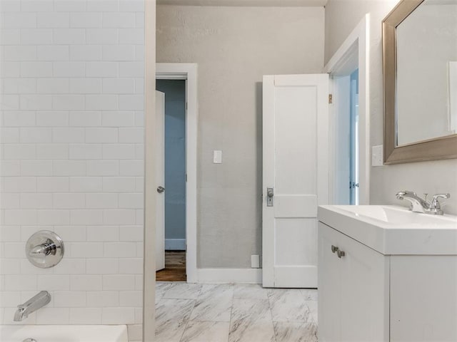 1017 N Broadway Ave, Shawnee, OK 74801 - bathroom featuring marble look tile flooring, vanity, and washtub / shower combination