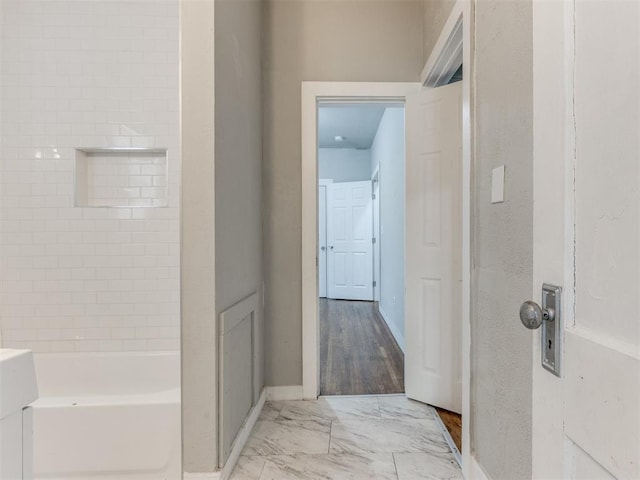 1017 N Broadway Ave, Shawnee, OK 74801 - full bathroom featuring marble look tile flooring, baseboards, and washtub / shower combination