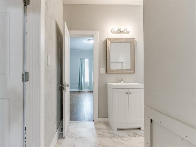 1017 N Broadway Ave, Shawnee, OK 74801 - bathroom with vanity, marble finish floors, and baseboards