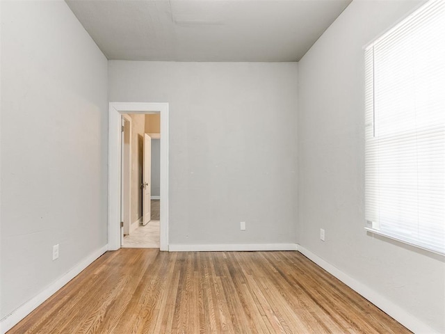 1017 N Broadway Ave, Shawnee, OK 74801 - spare room with wood finished floors, baseboards, and plenty of natural light