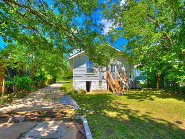 1017 N Broadway Ave, Shawnee, OK 74801 - view of side of property featuring a yard, stairs, and stone siding