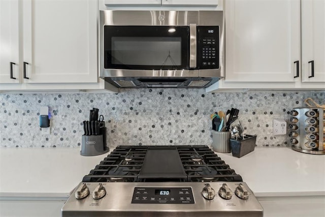 124 W 5th St, Arcadia, OK 73007 - kitchen with stainless steel appliances, white cabinetry, light countertops, and backsplash