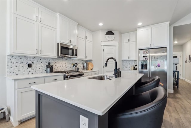 124 W 5th St, Arcadia, OK 73007 - kitchen featuring stainless steel appliances, light wood-style flooring, backsplash, white cabinetry, and recessed lighting