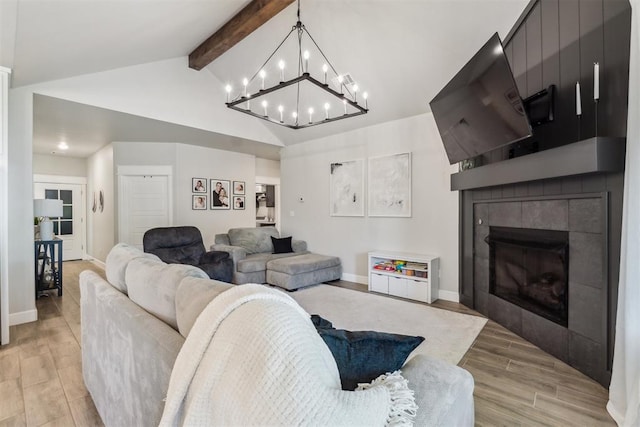 124 W 5th St, Arcadia, OK 73007 - living area featuring a chandelier, light wood-style flooring, and a tile fireplace