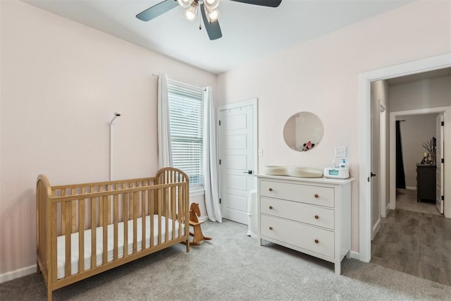 124 W 5th St, Arcadia, OK 73007 - bedroom with light carpet, a crib, and a ceiling fan