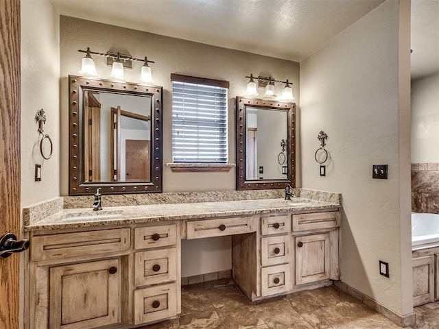 3501 Shell Ln, Yukon, OK 73099 - full bathroom featuring double vanity, a bathtub, a textured wall, and baseboards