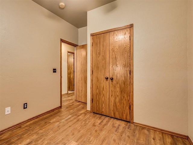 3501 Shell Ln, Yukon, OK 73099 - unfurnished bedroom with light wood finished floors, baseboards, and a closet
