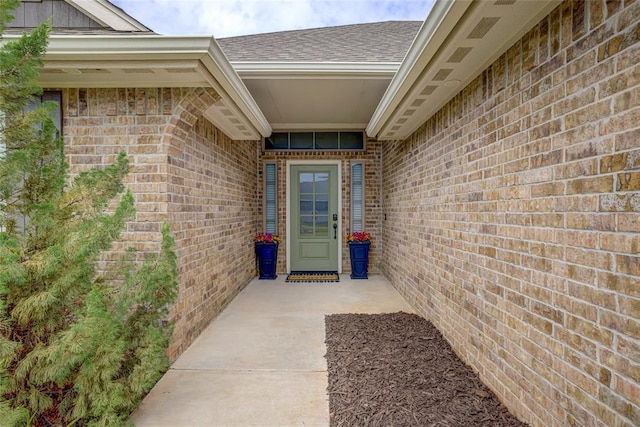 2613 Ethan Ln, Oklahoma City, OK 73160 - doorway to property featuring brick siding and roof with shingles
