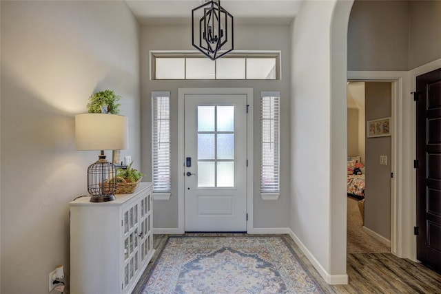 2613 Ethan Ln, Oklahoma City, OK 73160 - entrance foyer with arched walkways, wood finished floors, and baseboards