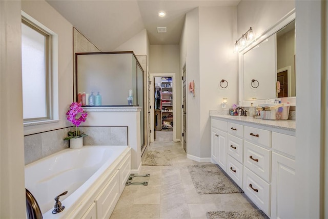 2613 Ethan Ln, Oklahoma City, OK 73160 - full bath with vanity, a stall shower, a garden tub, and tile patterned flooring