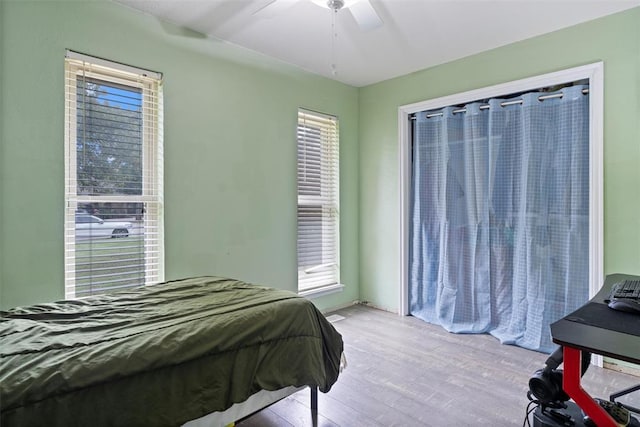 9703 Woodrock Ct, Oklahoma City, OK 73130 - bedroom featuring wood finished floors, multiple windows, and ceiling fan