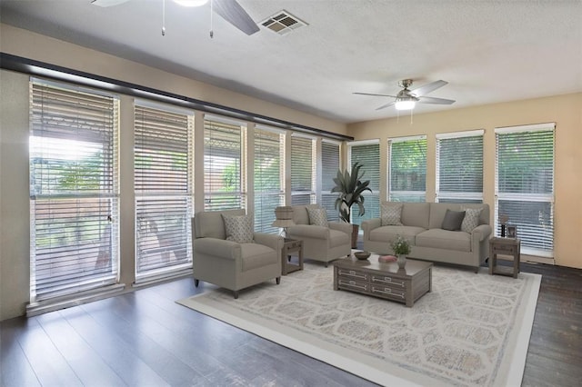 9703 Woodrock Ct, Oklahoma City, OK 73130 - living area with ceiling fan, wood finished floors, and a textured ceiling