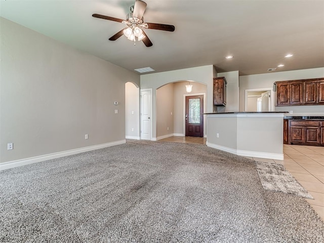 1861 Debbie Dr, Guthrie, OK 73044 - unfurnished living room featuring arched walkways, a ceiling fan, recessed lighting, light colored carpet, and baseboards