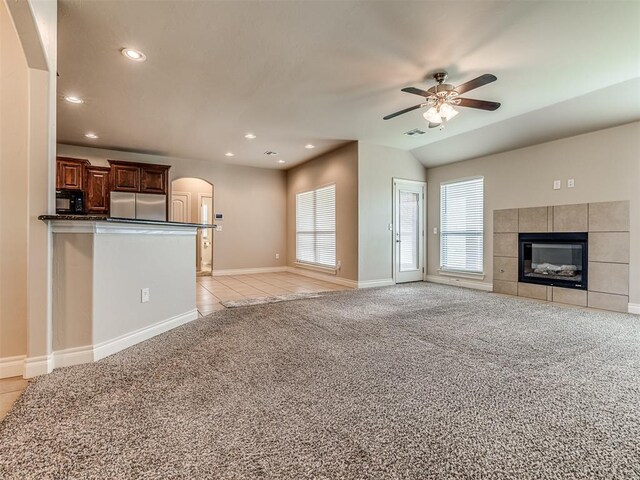 1861 Debbie Dr, Guthrie, OK 73044 - unfurnished living room with arched walkways, light colored carpet, a ceiling fan, recessed lighting, and a tiled fireplace