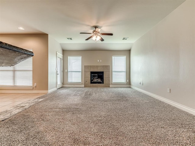 1861 Debbie Dr, Guthrie, OK 73044 - unfurnished living room featuring ceiling fan, carpet, baseboards, a tiled fireplace, and tile patterned floors