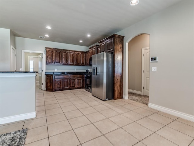 1861 Debbie Dr, Guthrie, OK 73044 - kitchen with stainless steel refrigerator with ice dispenser, dark countertops, arched walkways, recessed lighting, and black stove