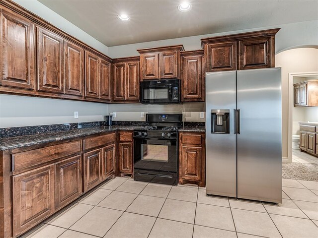 1861 Debbie Dr, Guthrie, OK 73044 - kitchen with black appliances, light tile patterned floors, dark stone countertops, dark brown cabinetry, and recessed lighting