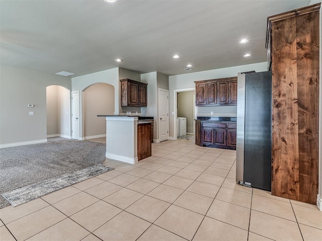1861 Debbie Dr, Guthrie, OK 73044 - kitchen with freestanding refrigerator, arched walkways, dark countertops, recessed lighting, and open floor plan