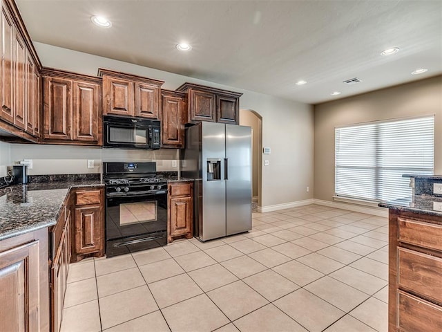 1861 Debbie Dr, Guthrie, OK 73044 - kitchen with black appliances, arched walkways, recessed lighting, baseboards, and light tile patterned floors