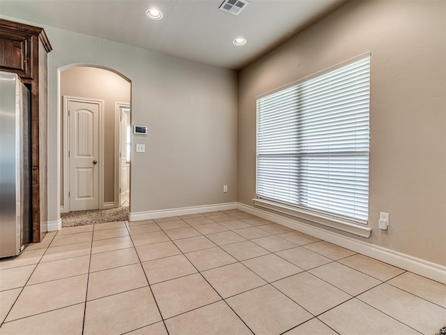 1861 Debbie Dr, Guthrie, OK 73044 - unfurnished room with arched walkways, light tile patterned floors, healthy amount of natural light, baseboards, and recessed lighting