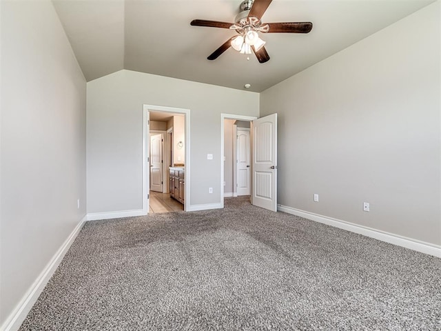 1861 Debbie Dr, Guthrie, OK 73044 - unfurnished bedroom featuring light carpet, lofted ceiling, baseboards, ensuite bathroom, and ceiling fan
