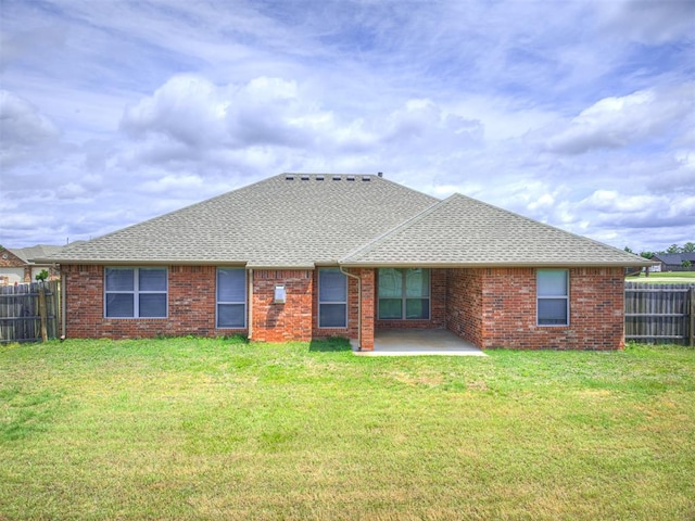 1861 Debbie Dr, Guthrie, OK 73044 - back of property with a shingled roof, a patio, and brick siding
