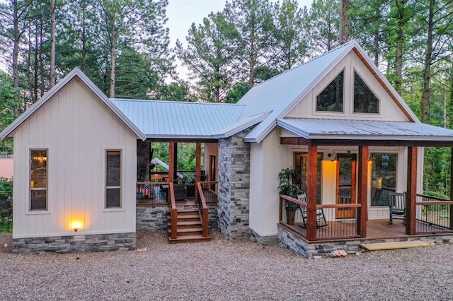 193 Pine Forest Trl, Broken Bow, OK 74728 - view of front of home with covered porch, metal roof, board and batten siding, and stone siding