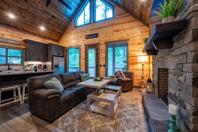 193 Pine Forest Trl, Broken Bow, OK 74728 - living room with high vaulted ceiling, wooden walls, healthy amount of natural light, and hardwood / wood-style floors