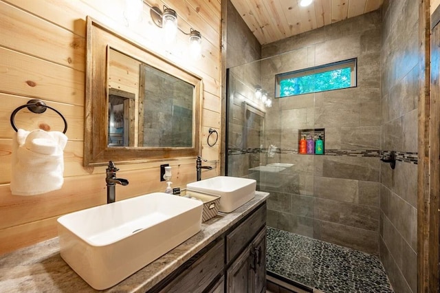 193 Pine Forest Trl, Broken Bow, OK 74728 - bathroom with a tile shower, double vanity, wooden walls, and recessed lighting