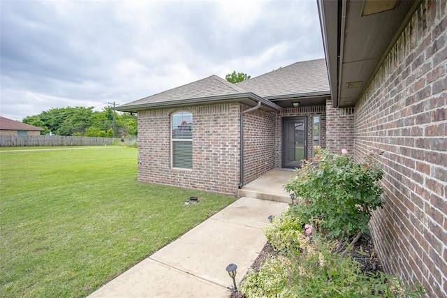 7521 Prairie Twyne Dr, Yukon, OK 73099 - view of exterior entry with brick siding and a shingled roof