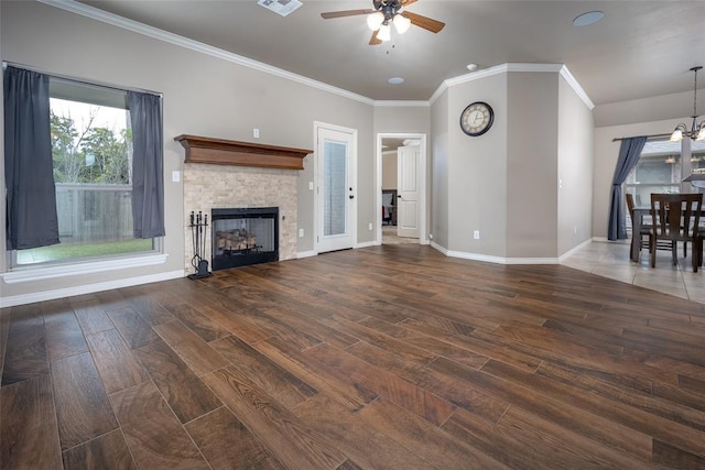 7521 Prairie Twyne Dr, Yukon, OK 73099 - unfurnished living room featuring ceiling fan, wood finished floors, ornamental molding, baseboards, and a glass covered fireplace