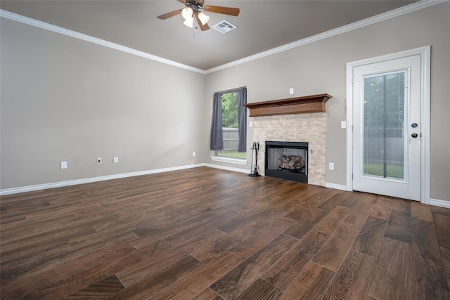 7521 Prairie Twyne Dr, Yukon, OK 73099 - unfurnished living room with ceiling fan, crown molding, a stone fireplace, wood finished floors, and baseboards