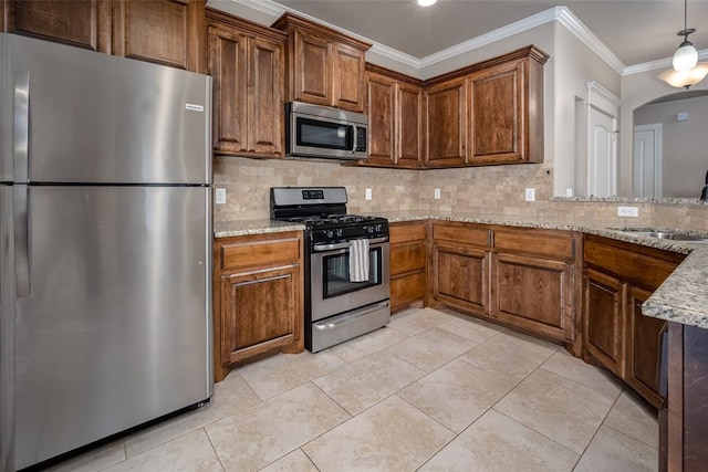 7521 Prairie Twyne Dr, Yukon, OK 73099 - kitchen featuring appliances with stainless steel finishes, a sink, backsplash, ornamental molding, and light stone counters