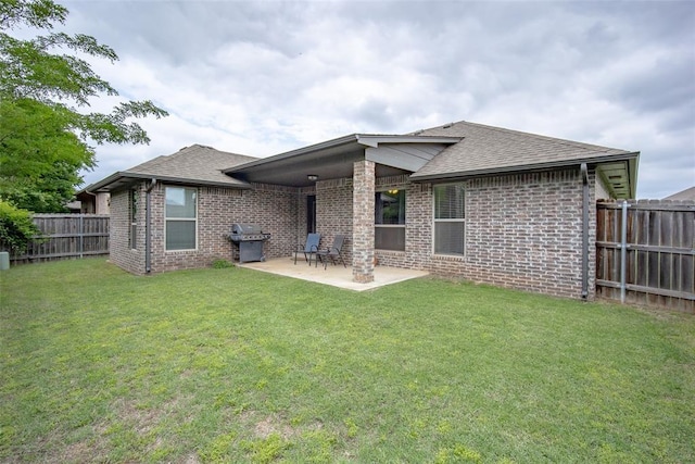 7521 Prairie Twyne Dr, Yukon, OK 73099 - back of property with brick siding, roof with shingles, and a patio area