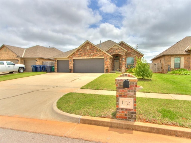 11728 SW 15th Ter, Yukon, OK 73099 - view of front of home with a garage, concrete driveway, brick siding, and roof with shingles
