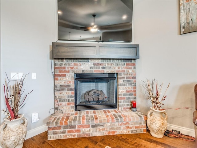 11728 SW 15th Ter, Yukon, OK 73099 - detailed view of a fireplace, ceiling fan, baseboards, and wood finished floors