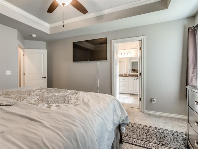 11728 SW 15th Ter, Yukon, OK 73099 - bedroom with ornamental molding, a raised ceiling, carpet, connected bathroom, and baseboards