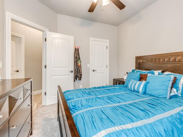 11728 SW 15th Ter, Yukon, OK 73099 - bedroom with light colored carpet and a ceiling fan