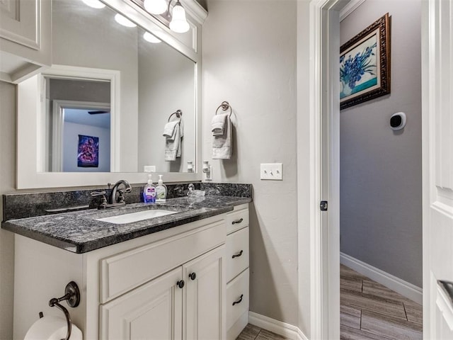 11728 SW 15th Ter, Yukon, OK 73099 - bathroom with vanity, baseboards, and wood finished floors