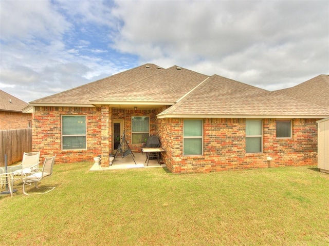 11728 SW 15th Ter, Yukon, OK 73099 - back of house featuring a shingled roof, brick siding, and a patio
