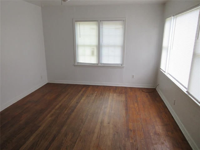 608 W Walnut St, Tecumseh, OK 74873 - empty room with dark wood finished floors and baseboards