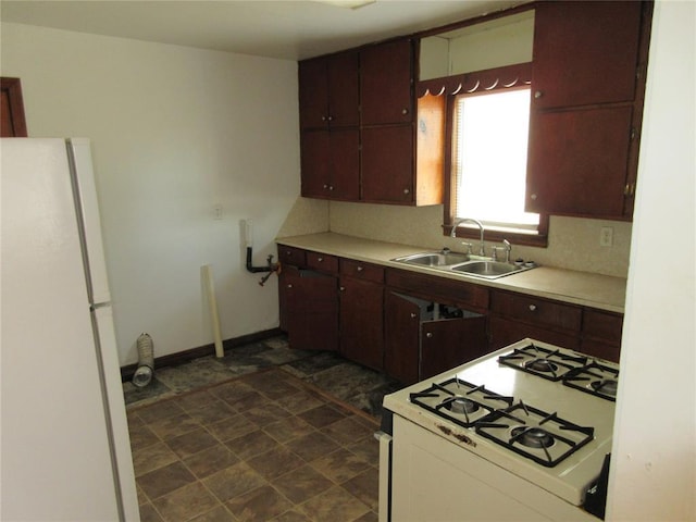 608 W Walnut St, Tecumseh, OK 74873 - kitchen with white appliances, a sink, light countertops, and baseboards